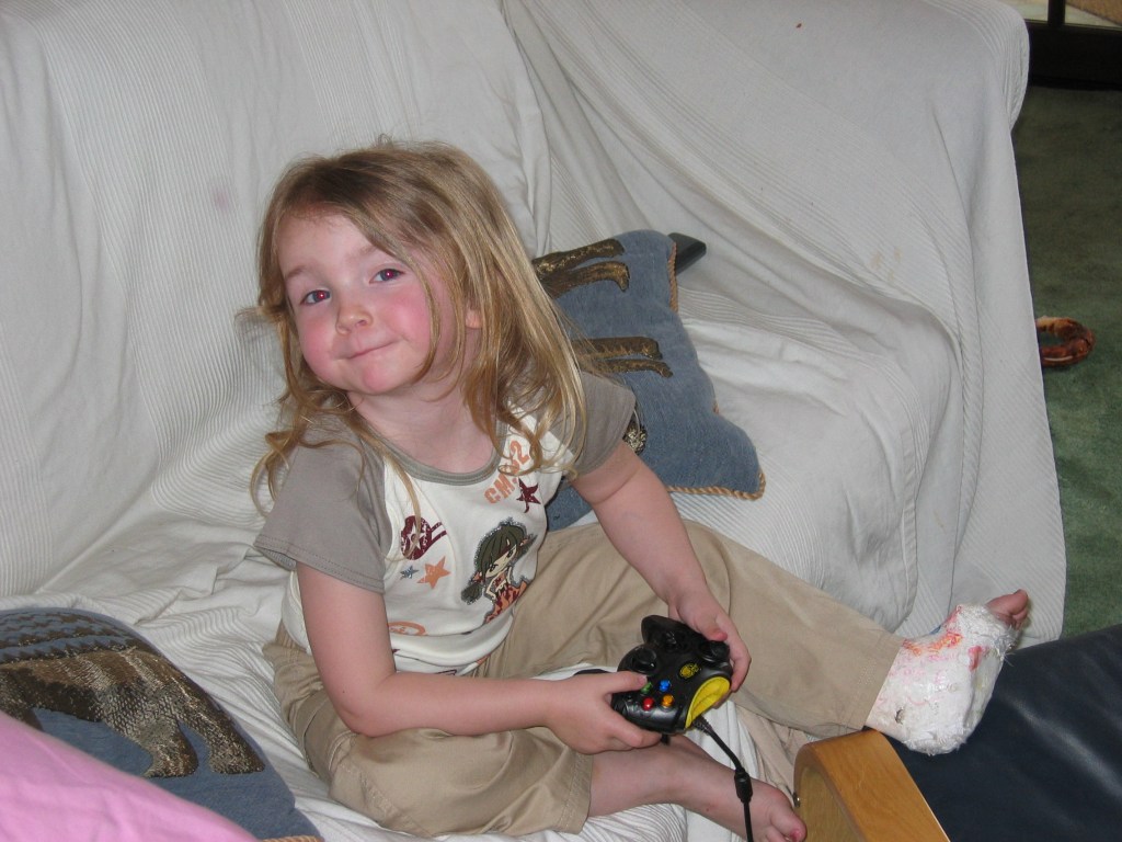 Leia playing Xbox, leg in&nbsp;pot